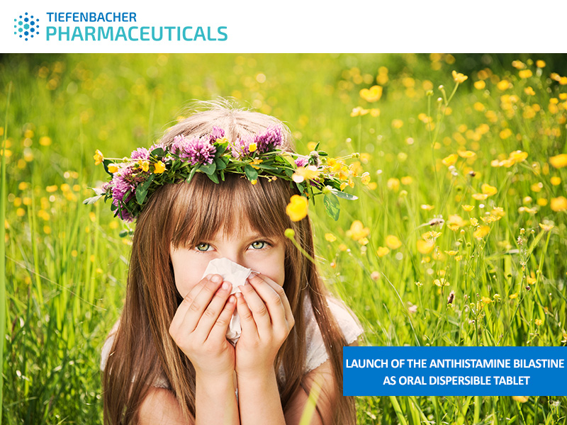 Tiefenbacher Group - A young girl with a flower crown sits in a field of wildflowers, holding a tissue to her nose. Text reads: "Launch of the antihistamine bilastine as oral dispersible tablet—a finished dosage form." TIEFENBACHER PHARMACEUTICALS logo appears above.
