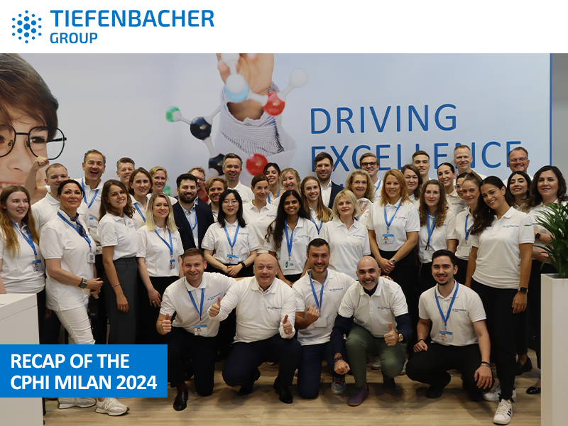 Tiefenbacher Group - A large group of smiling people in white polo shirts with blue lanyards pose together at the Tiefenbacher Group booth at CPHI Milan 2024, showcasing their family-owned pharmaceutical company’s commitment to patient-centric drug development.